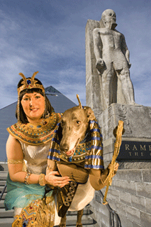 picture of greyhound owner in Egyptian costume posing with greyhound in front of pyramid in Memphis, TN